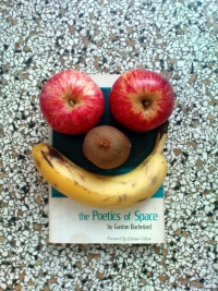 Image:The Beacon Press first edition of The Poetics of Space by Gaston Bachelard covered by a banana, a kiwi and two apples