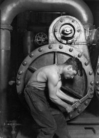 "Powerhouse mechanic working on steam pump," 1920